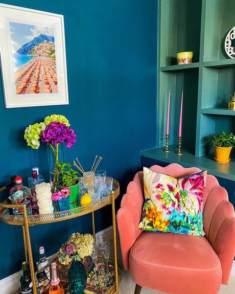 Gorgeous blue living room with gold bar cart and pink velvet armchair. Featuring our Antique Gold Metal Bar Cart. Image by @notting.hiller