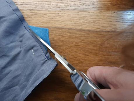 Cutting away the excess felt from the seams of my cat bag