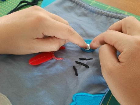 The final touches on my cat bag: glueing the googly eyes