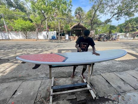 man-waxing-a-board-at-Dylans-surf-shop-arugam-bay