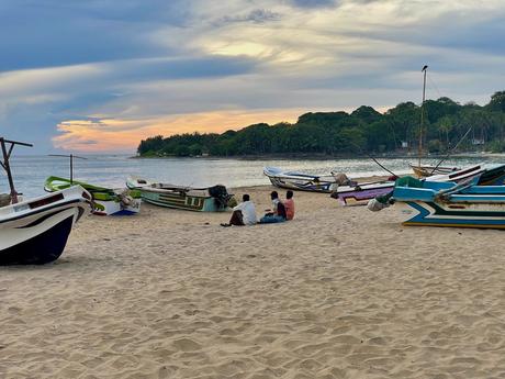 friends-sitting-on-the-beach-watching-sunset-in-arugam-bay