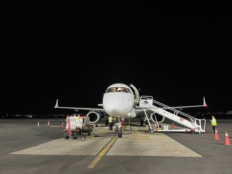 Flight-attendant-quotes-airplane-on-tarmac-at-night