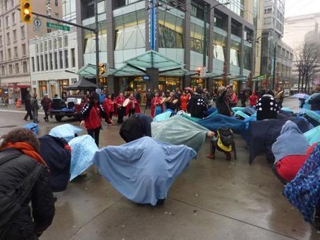 A gathering in Vancouver Friday performed a flash mob to protest Taskeo Mines Ltd.’s New Prosperity Mine.— Image Credit: Photo Submitted