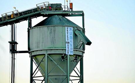 CLEAR MESSAGE: Activists unfurl a banner on a coal loader at Idemitsu’s Boggabri coalmine yesterday, forcing operations to be stopped.