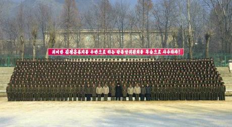 Kim Jong Un poses for a commemorative photo with officers and service members of the command element of KPA Unit #526 (Photo: Rodong Sinmun).