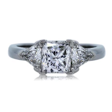 Princess cut diamond ring with trillion accent stones in platinum