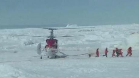 Still image taken from video shows rescue workers making their way from a helicopter to Russian ship Akademik Shokalskiy, which has been trapped in Antarctic ice since Christmas Eve, in East Antarctica