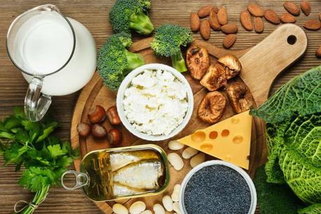 An array of calcium-rich foods, including milk, cheese, sardines and broccoli.