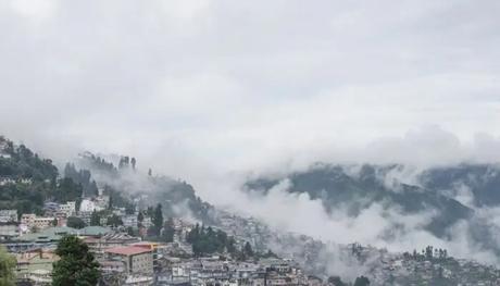 mountains and city covered in clouds