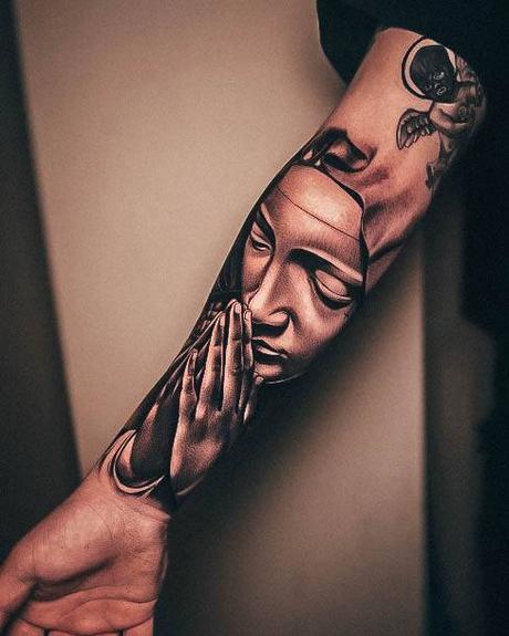 Tattoo of praying hands with the Virgin Mary