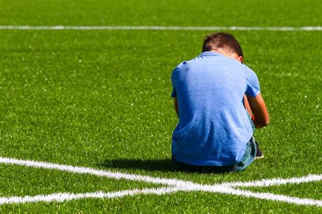 A child looks sad at football.