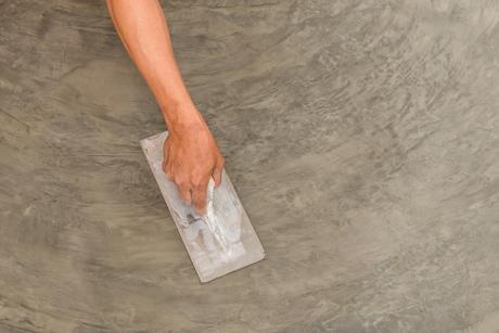 professional hands finishing the concrete floor
