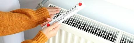 a woman checking the efficiency of her radiator output