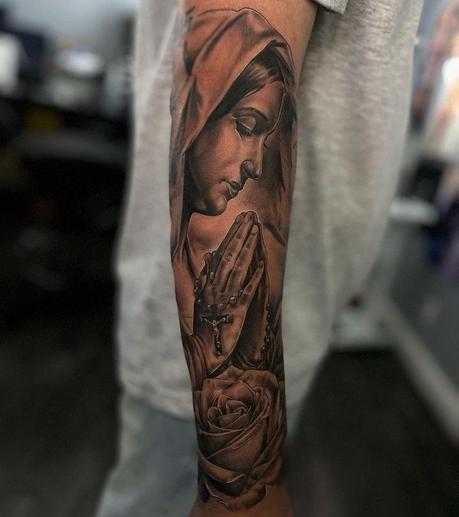 Full-sleeve Virgin Mary tattoo praying with rosary beads