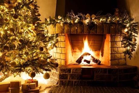 a Christmas tree placed next to an open fire