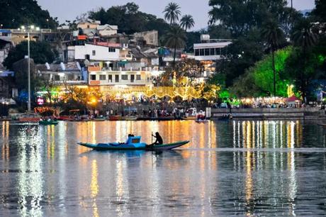 35 Appealing Destinations To Explore In India In March 2023 a boat rowing on a lake at night