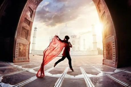 35 Appealing Destinations To Explore In India In March 2023 A girl with red scarf in front of Taj Mahal in Agra