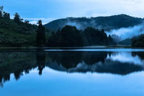 35 Appealing Destinations To Explore In India In March 2023 reflection of mountains and trees on a lake