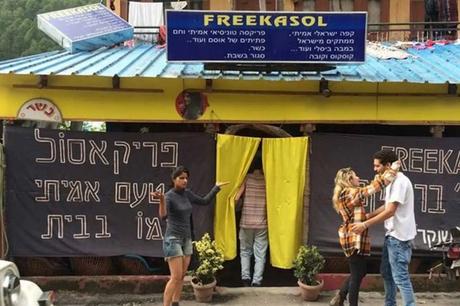     people standing outside a cafe