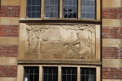 Stone relief of an agricultural scene and a naked god.