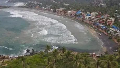 A breathtaking view of sea in Kovalam surrounded by lush greenery
