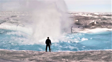 Alun Hubbard stands next to a moulin that forms in a meltwater flow on the Greenland ice sheet.  Thanks to Alun Hubbard