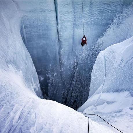 Alun Hubbard abseils into a moulin in October 2019, a point in the year when surface melting should have stopped, but it didn't.  Lars Ostenfeld / In the ice