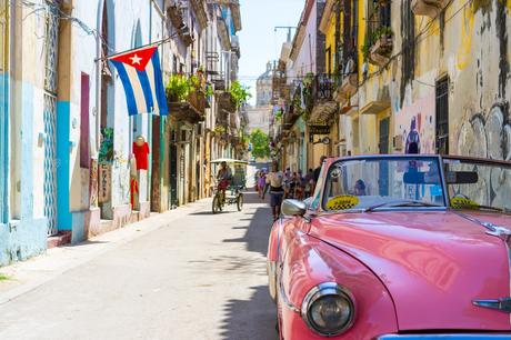 pink vintage car and old colonial buildings in havana