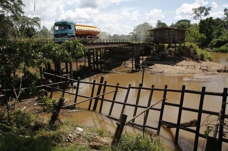 An oil tanker crosses a bridge over the Amazon River. Oil exploration in the interior of Ecuador is increasingly threatening the traditional lives of indigenous people living on their ancestral lands. Credit: Julio Etchart / Panos