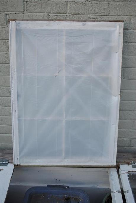 A double thickness of 3.5 mil plastic sheeting compensates for the broken glass panes.