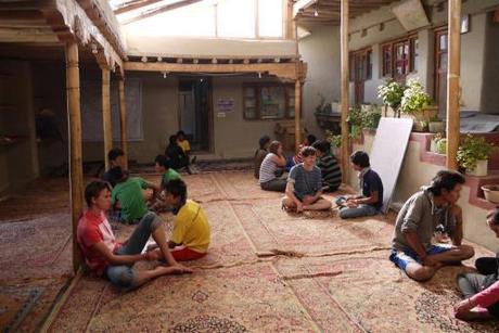 Classrooms are airy and light, no desks, everyone sits on the floor and writes on their laps. 