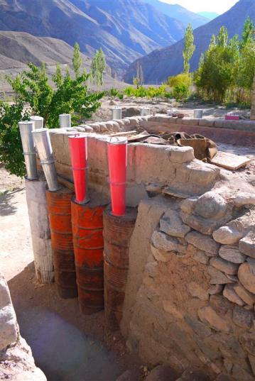 Rice is stored sensibly in re-used metal drums and is kept cool and dry in this mud built store room. 