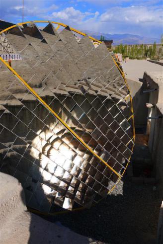 Food is cooked almost entirely on these incredible outer focus solar cookers that concentrate the light through a hole in the wall so there is no need to cook outside.  