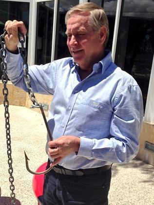 Premier Colin Barnett holding a hook, which is part of the baited drum line that will be used to catch and kill sharks.