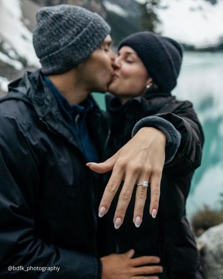 winter engagement photos couple is kissing after proposal