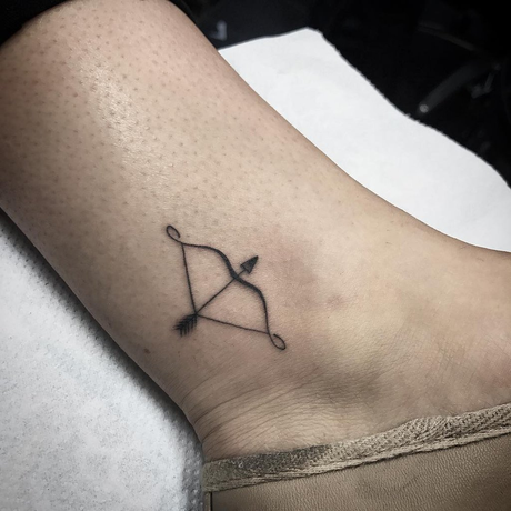 21 Hottest Ankle Tattoo Ideas: Simple Designs with Significance to Kickstart 2024! 25 Minimal bow and arrow tattoo on ankle