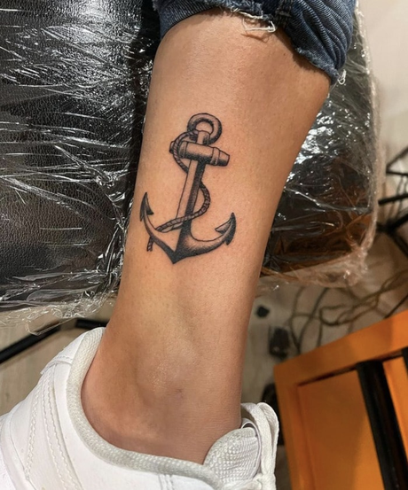 21 Hottest Ankle Tattoo Ideas: Simple Designs with Significance to Kickstart 2024! 14 Ship anchor and rope tattoo on ankle in black ink