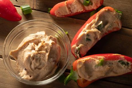bowl of vegan chipotle cream cheese and stuffed mini peppers