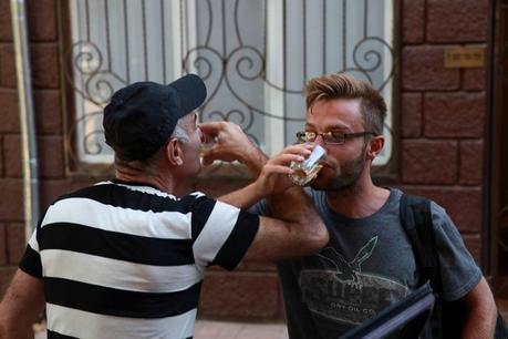 Alex Tiffany drinking wine with a georgian man on the street in georgia