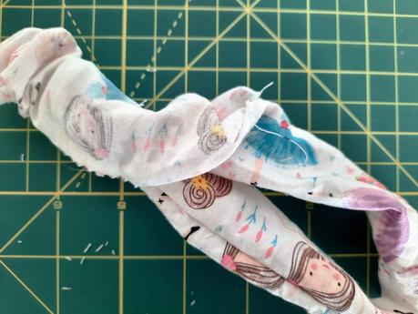 Sewing a scrunchie: turn the fabric tube upright using the opening at the bottom