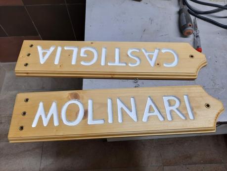 Splitting the wooden sign into two halves
