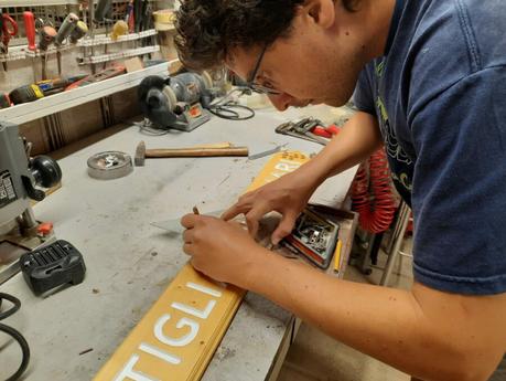 Splitting the wooden sign into two halves: measuring