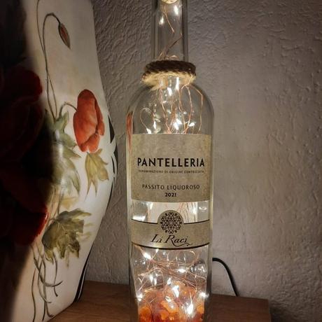 Bottle lamp with colored glass scraps inside