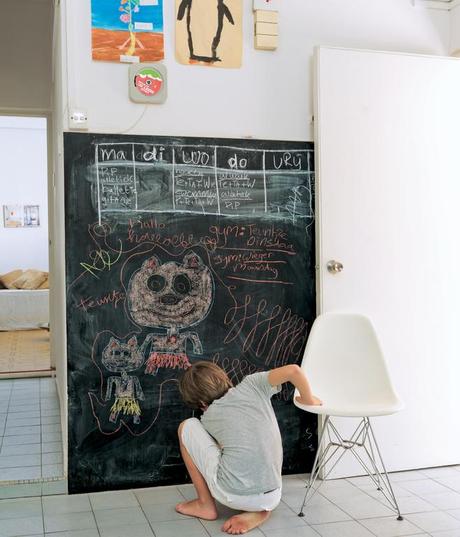 
  In December 2007, Nicolette de Waart, her husband, Joost Dop, and their four children moved from Heemstede, the Netherlands, to Singapore. De Waart founded an interior design business and made over their own home first—including adding a chalkboard to the kitchen for writing memos and for drawing, as Tammo does here. Photo by Jasper James.
 
  
