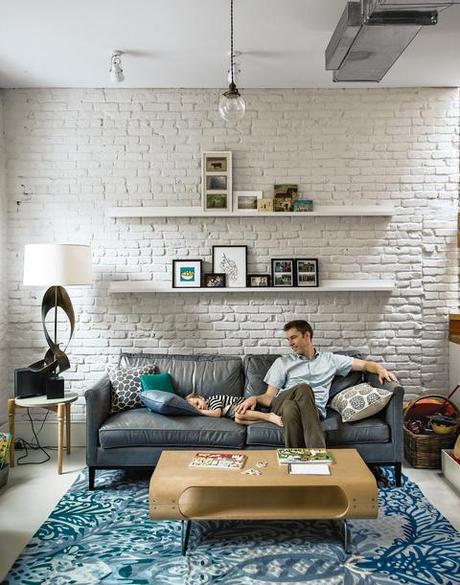 Modern living room with exposed painted brick walls