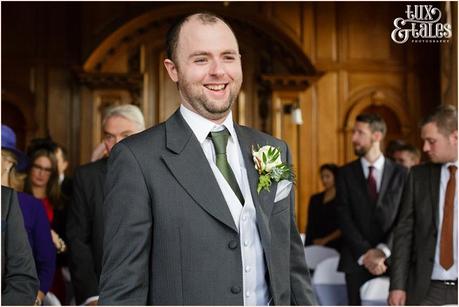 Groom laughs waiting for bride at York wedding