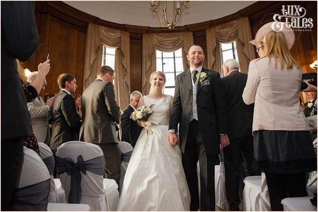 Bride and groom walk back up aisle at Cedar Court Grand Hotel Wedding.