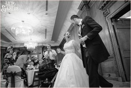 Bride and groom laugh as they walk into the evening reception at The Cedar Court Grand