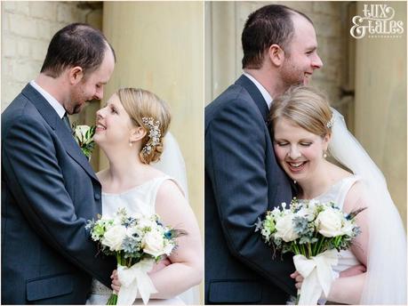 Bride and groom smile and hug at York winter wedding