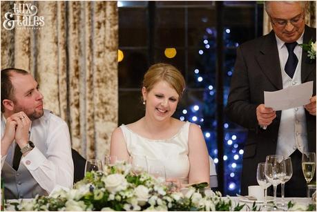 Bride smiles during speeches at York wedding